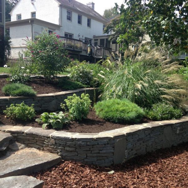 Dry stack stone walls and flower beds