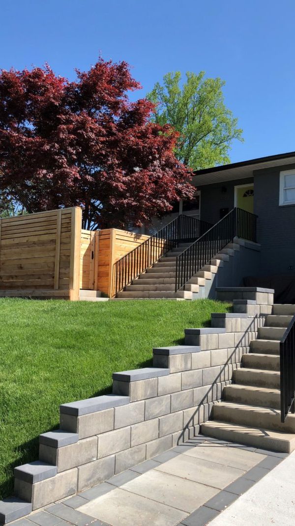 Stone steps, Iron railings, Paver patio, Paver retaining wall, Fence, Sod